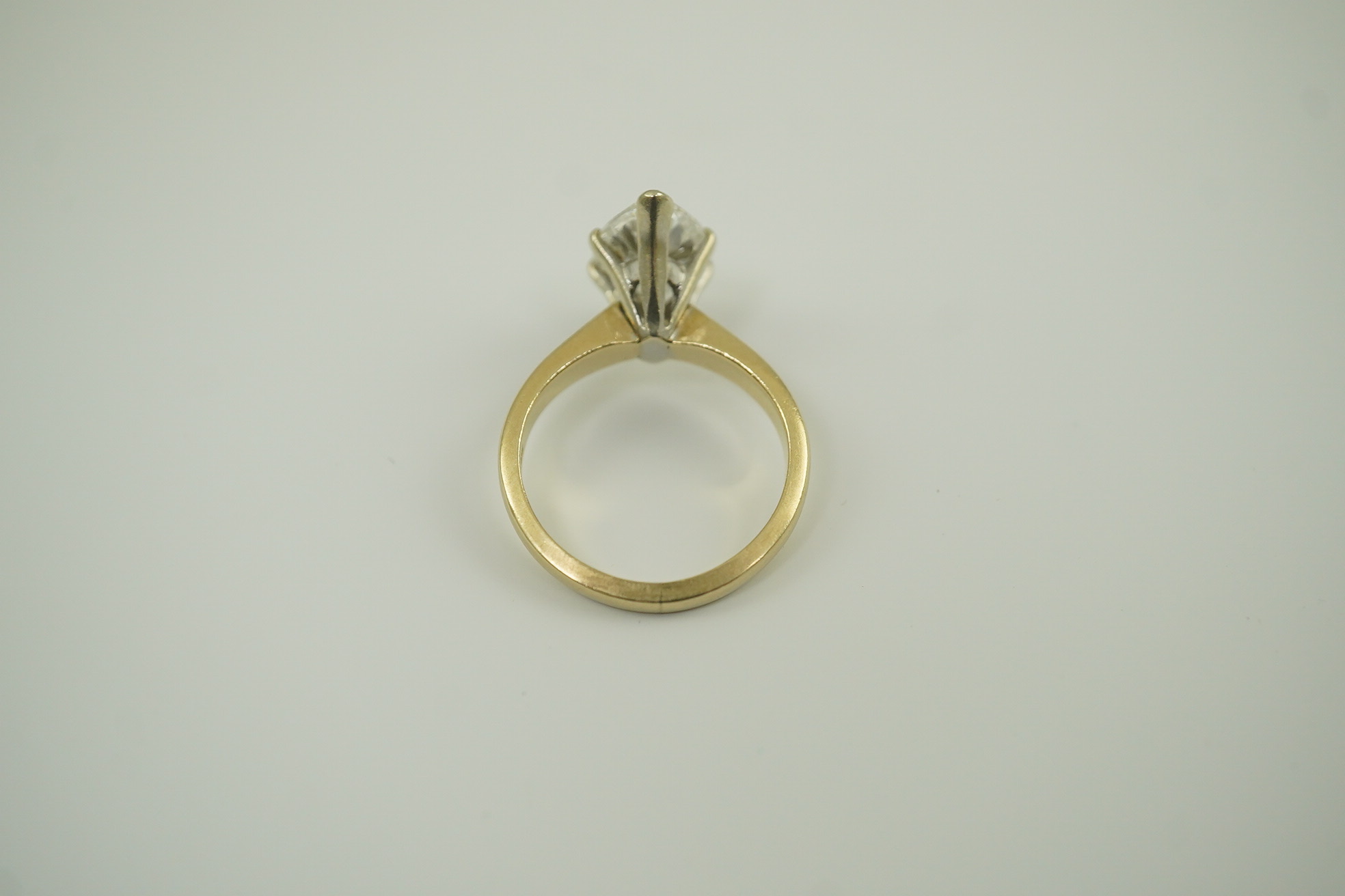 A modern 14k gold and solitaire marquise diamond set ring